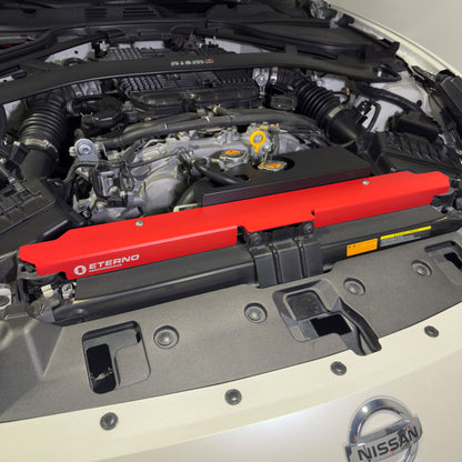 Nissan 370Z radiator core support plate installed in engine bay – red powder coat